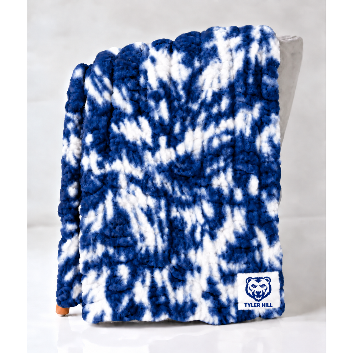 Blue and white tie dye plush throw blanket with Tyler Hill logo patch